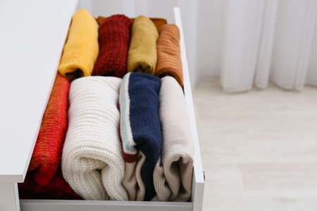 Modern chest of drawers with clothes in room, closeupの写真素材