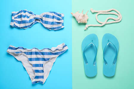 Summer composition with beach accessories on color background