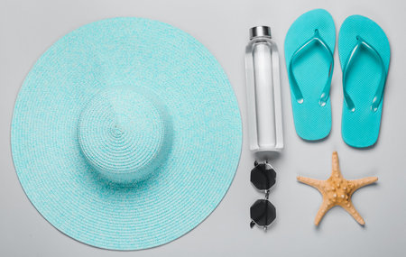 Summer composition with beach accessories on light background