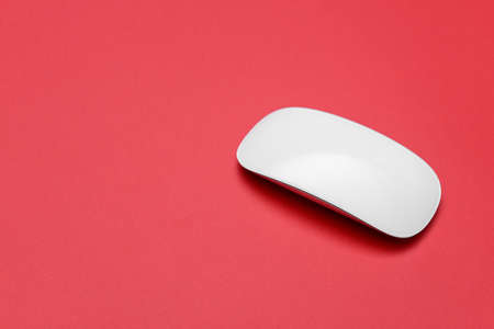 Modern computer mouse on color backgroundの写真素材