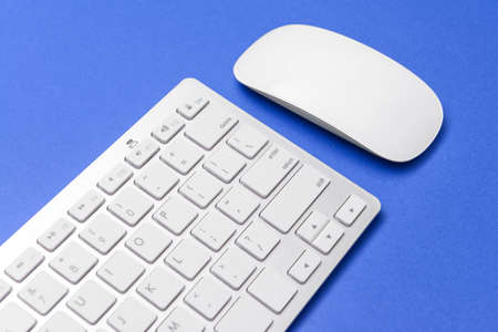 Modern computer mouse and keyboard on color backgroundの写真素材