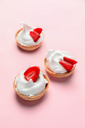 Tasty tartlets with strawberry on color backgroundの写真素材