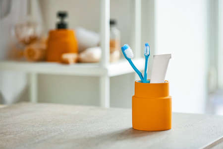 Tooth brush and paste on table in bathroomの写真素材