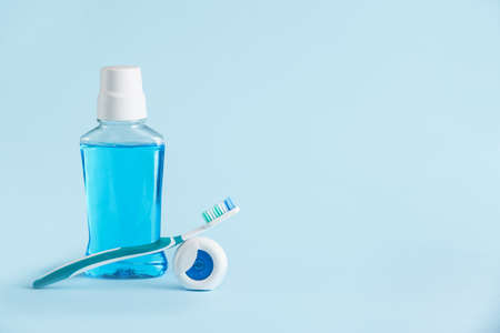 Tooth brush, mouth rinse and paste on color backgroundの写真素材