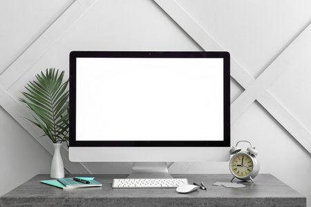 Modern PC monitor with blank screen on table