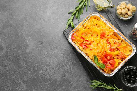 Tasty baked pasta in dish on dark backgroundの写真素材