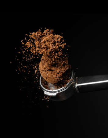 Portafilter with coffee powder on dark backgroundの写真素材