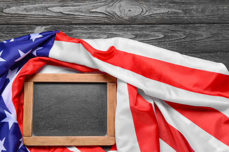 USA flag and chalkboard on dark wooden backgroundの写真素材