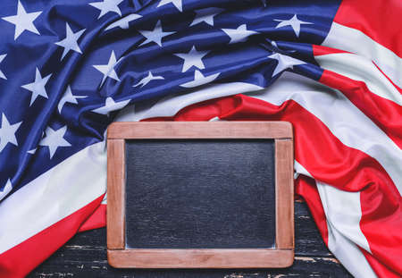 USA flag and chalkboard on wooden backgroundの写真素材