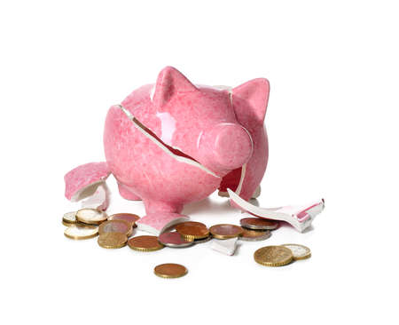Broken piggy bank and coins on white backgroundの写真素材