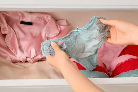 Woman with stylish female lingerie in open drawer, closeupの写真素材