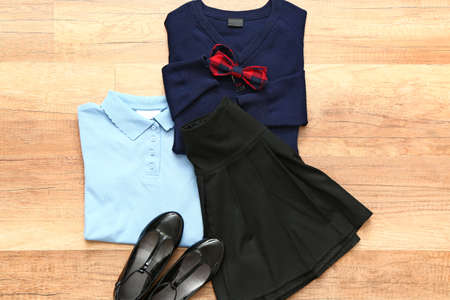Stylish school uniform on wooden backgroundの写真素材