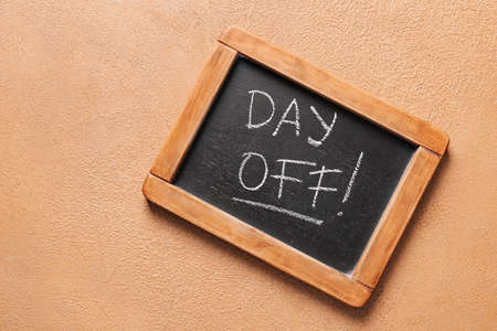 Chalkboard with text DAY OFF on color background