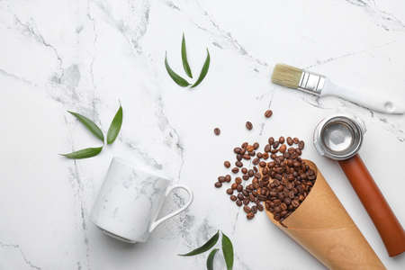 Coffee beans with cup, portafilter and brush on white background