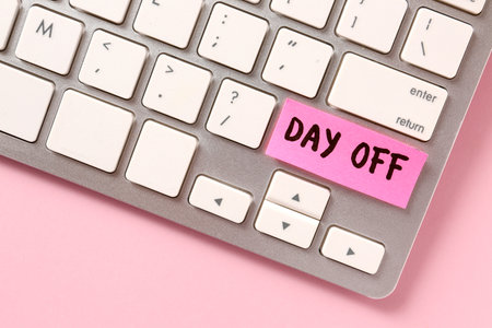 Computer keyboard with text DAY OFF on color background