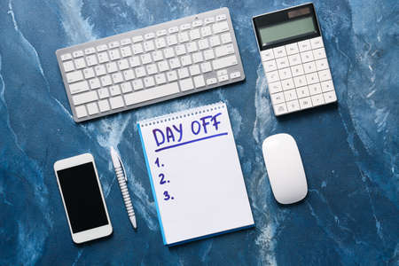 Notebook with empty to-do list and text DAY OFF at workplace