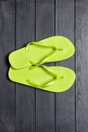 Stylish flip-flops on wooden backgroundの写真素材