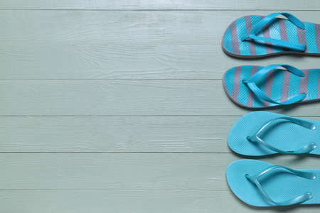 Stylish flip-flops on wooden backgroundの写真素材