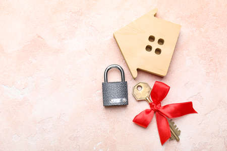 Key from house and padlock on color backgroundの写真素材