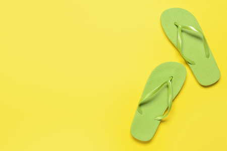 Stylish flip-flops on color backgroundの写真素材