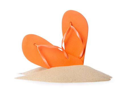 Stylish flip-flops and beach sand on white backgroundの写真素材