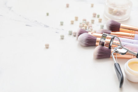 Set of makeup brushes with cosmetics on white backgroundの写真素材