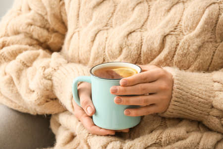 Woman with cup of hot tea at home, closeupの写真素材