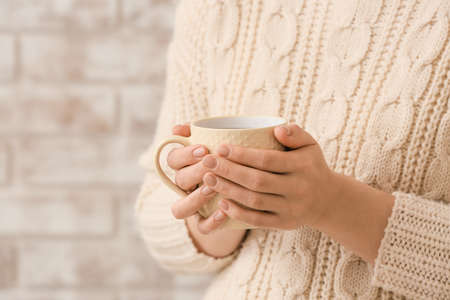 Woman with cup of hot tea at home, closeupの写真素材