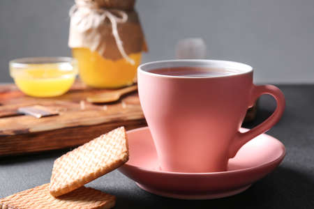 Cup of hot tea and cookies on tableの写真素材