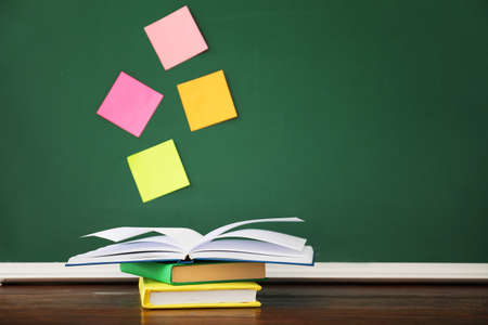 Stack of books on table in classroom