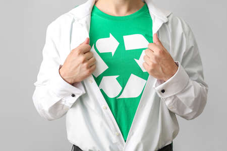 Man wearing t-shirt with recycling sign on gray background. Ecology conceptの写真素材