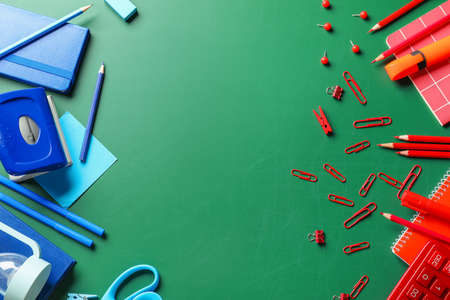 Set of school stationery on blackboard