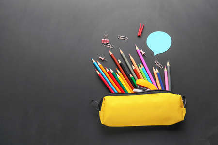 Set of school stationery on blackboard
