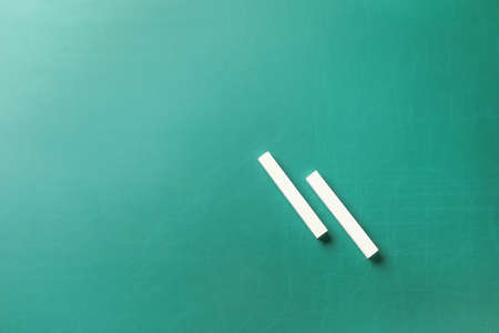 Pieces of chalk on blackboard, top viewの写真素材