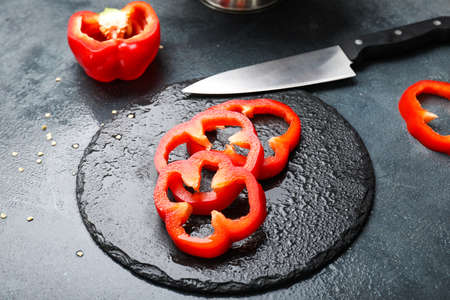 Red cut bell pepper on table