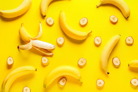 Ripe bananas on color backgroundの写真素材