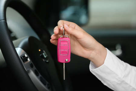 Woman with key in car salonの写真素材