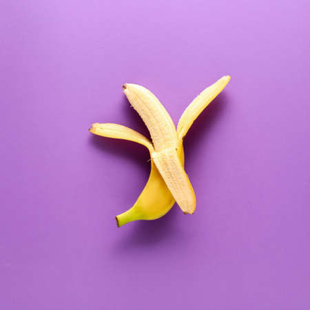 Ripe banana on color backgroundの写真素材