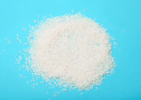 Heap of rice on color backgroundの写真素材