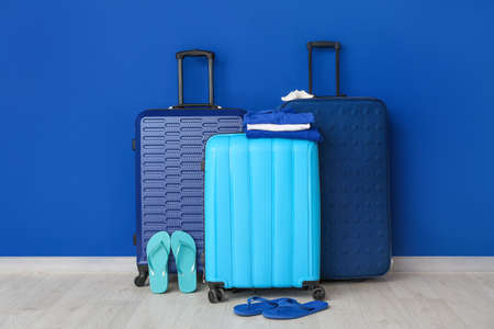 Packed luggage near color wall. Travel conceptの写真素材