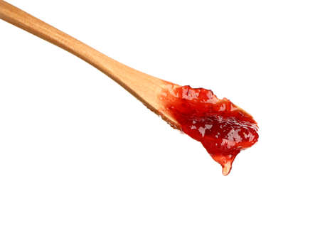 Spoon with tasty strawberry jam on white backgroundの写真素材