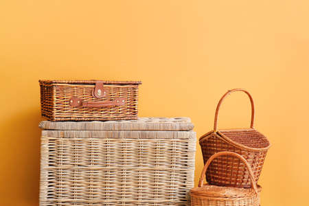 Different wicker baskets near color wallの写真素材