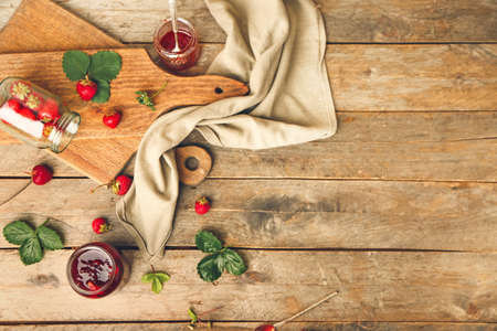 Jars of tasty strawberry jam on tableの写真素材