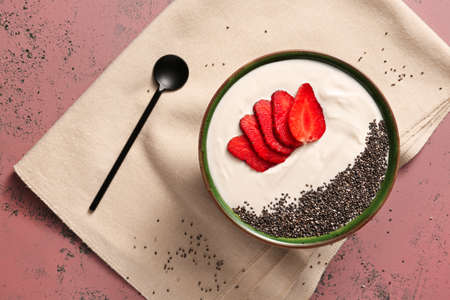 Bowl of healthy strawberry yogurt on color backgroundの写真素材