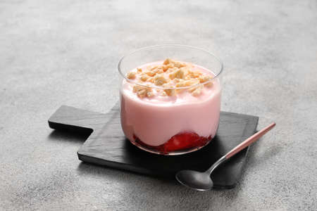 Glass of healthy strawberry yogurt on tableの写真素材
