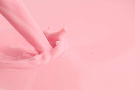 Pouring of fresh pink milk, closeupの写真素材