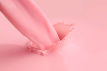 Pouring of fresh pink milk, closeupの写真素材