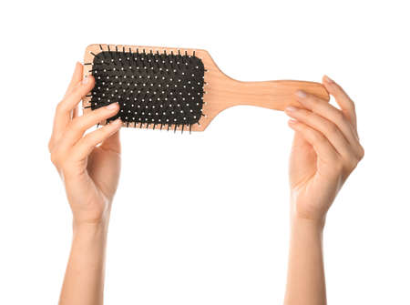 Woman hands and paddle brush on white background
