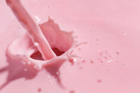 Pouring of fresh pink milk, closeupの写真素材
