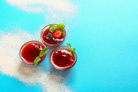 Bowls of tasty strawberry jam on color backgroundの写真素材